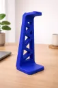Vibrant blue headphone stand on desk.webp